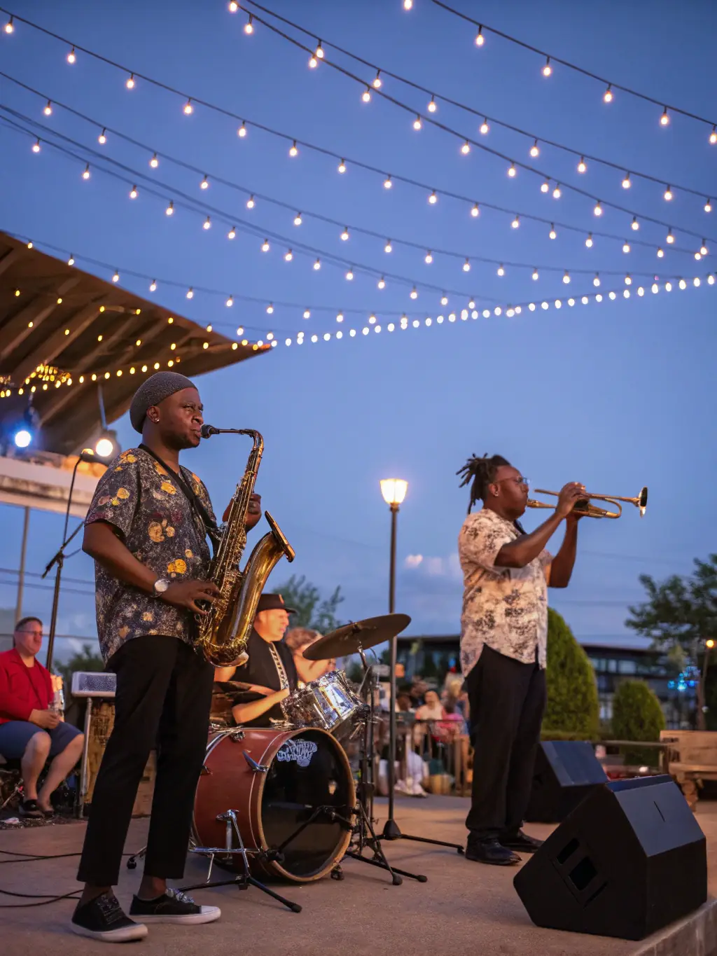 A diverse audience enjoying a jazz performance in an outdoor setting, capturing the inclusive and engaging atmosphere of JAZZONOTES ASSOCIATION events.